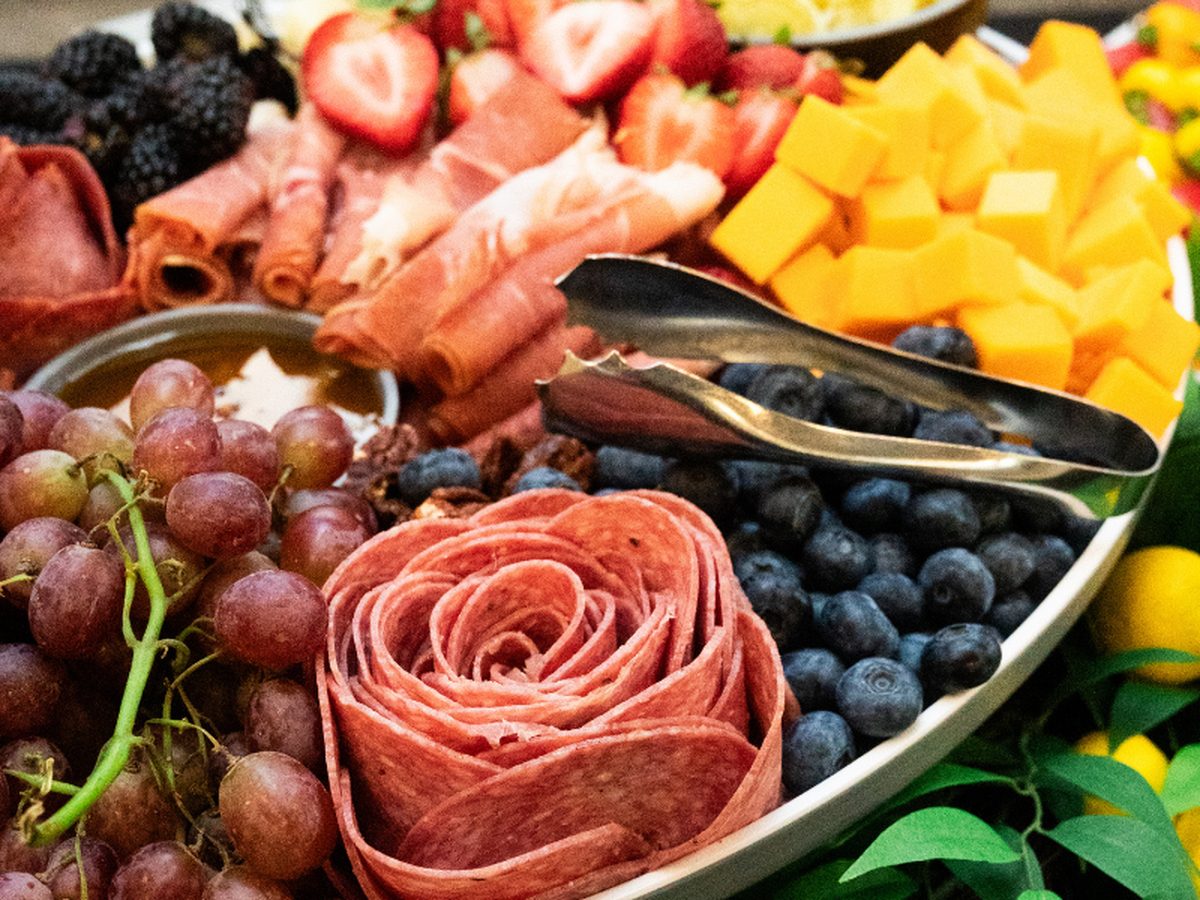 A grazing platter of charcuterie, cheese and fresh fruit